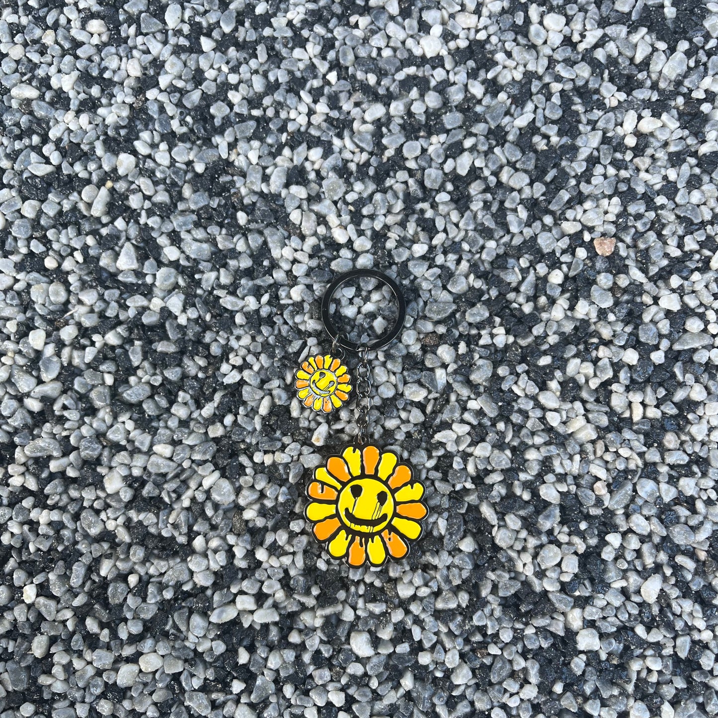 Two yellow flower-shaped objects on a textured gray surface