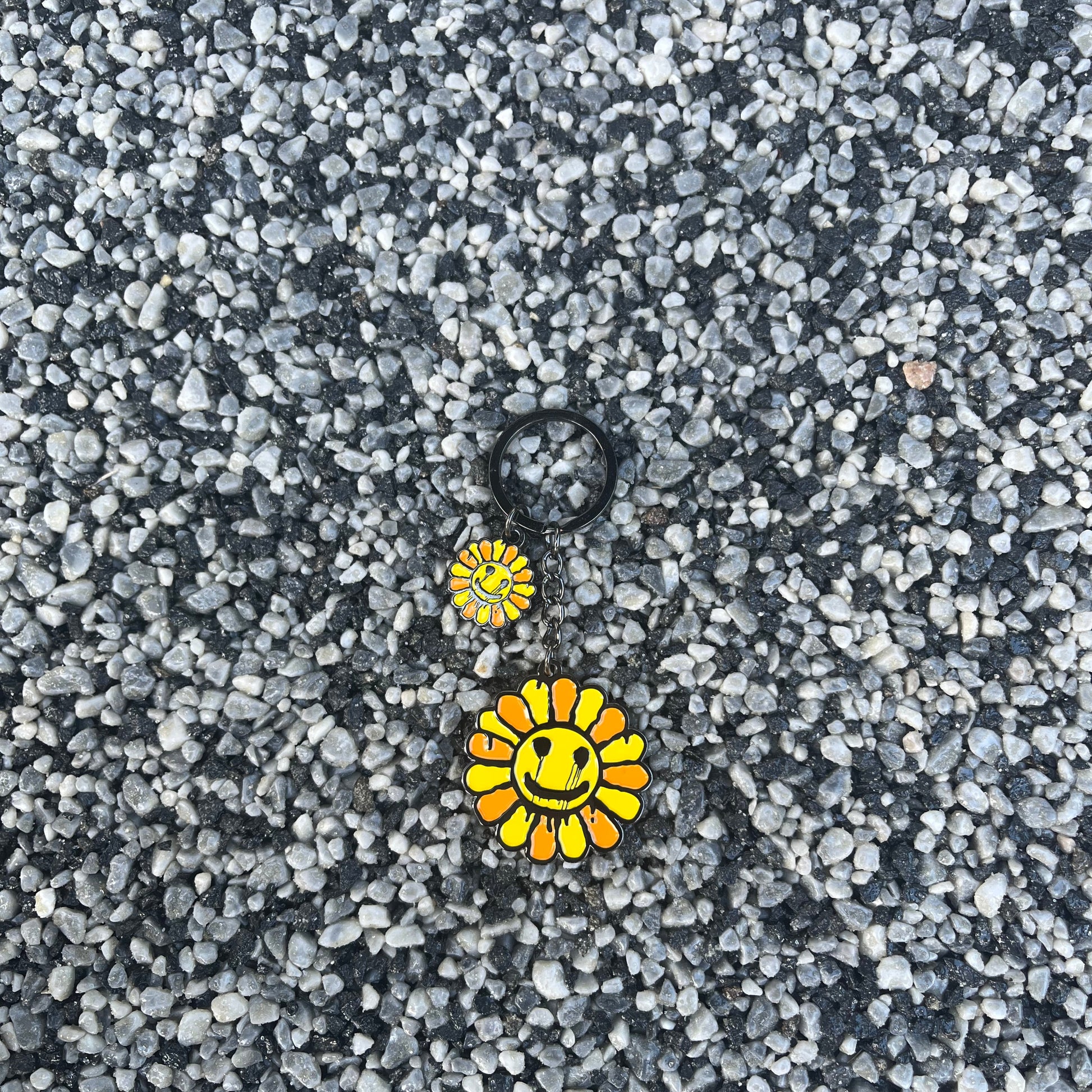 Two yellow flower-shaped objects on a textured gray surface