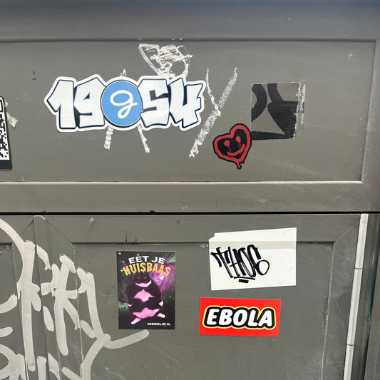 Graffiti and stickers on a metallic surface